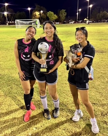 Three ladies and a soccer trophy
